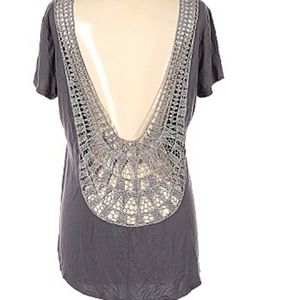 Top with low open back with embroidery  trim.